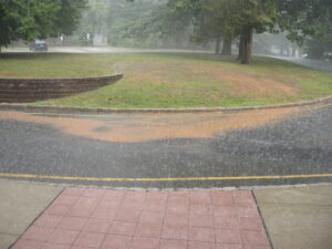 Sediment laden runoff from landscape with poor soil cover.